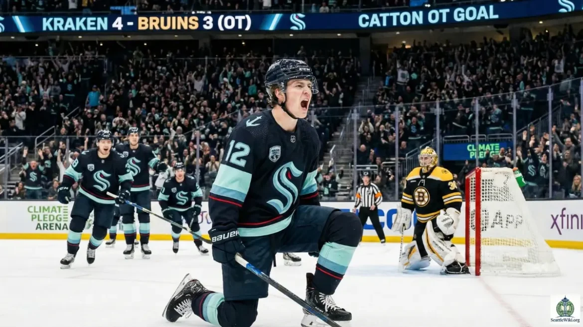 Berkly Catton, Seattle Kraken, Boston Bruins, NHL, Hockey, Climate Pledge Arena, Kraken Game, 2026 Season, Berkly Catton skating with puck against Bruins defender, Seattle Kraken goal celebration overtime, Climate Pledge Arena scoreboard showing 4-3 score, Berkly Catton faceoff vs Boston Bruins, Seattle Kraken fans cheering in stands, Dan Bylsma coaching on bench, Berkly Catton post game interview 2026